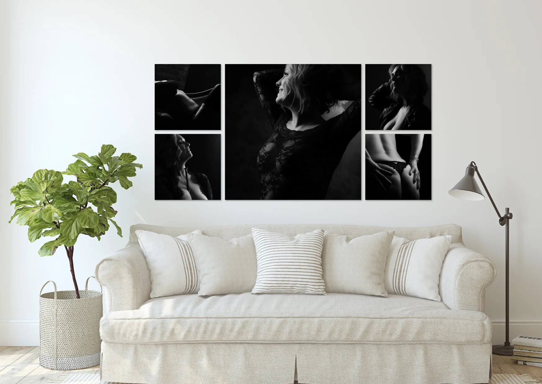 A black and white wall collection of portraits above a cream sofa