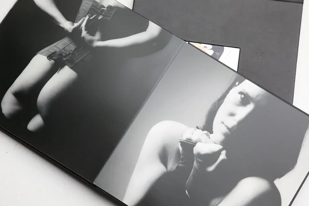 An open Divine Divas photographic album